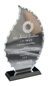 Progress Lakeshore award trophy, made of glass and cut in the shape of a flame, carved with the words' 2021 Annual Excellence in the category of Corporate Investment goes to Wisconsin Aluminum Foundry, sponsored by CLA.'