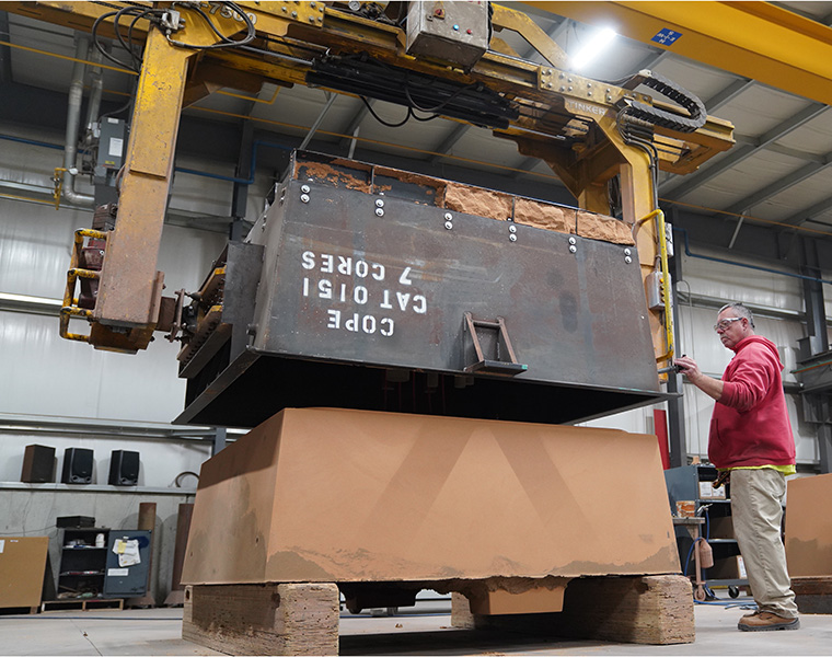 Wisconsin Aluminum Foundry worker operates a precision air set molding machine.
