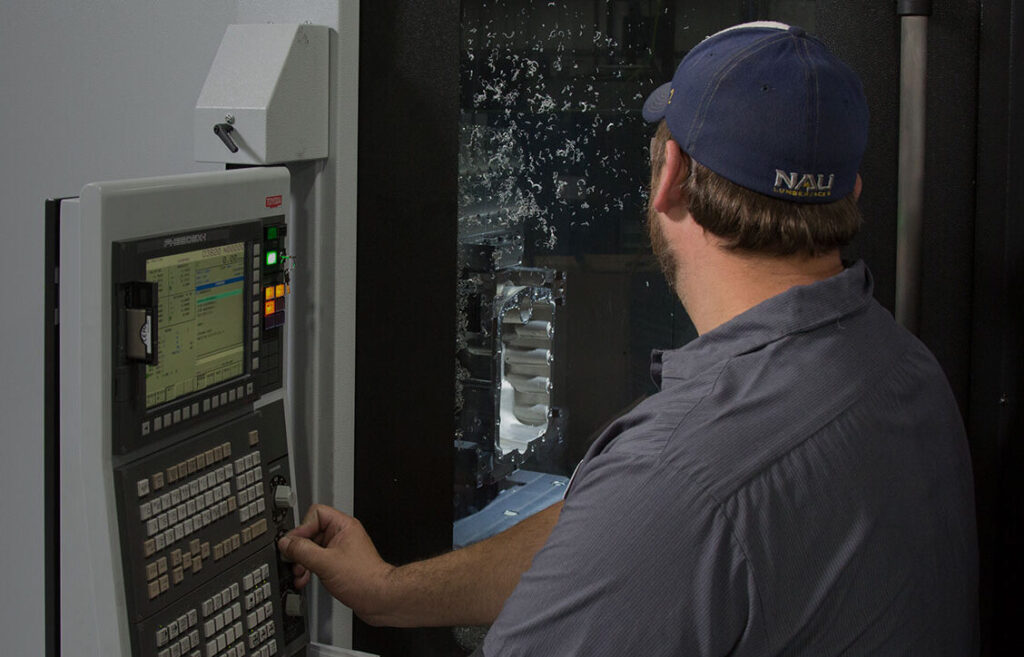 At Manitowoc Pattern & Machining, a subsidiary of Wisconsin Aluminum Foundry, a worker operates precision machining equipment.