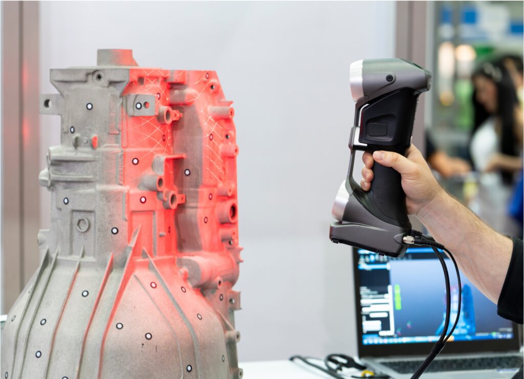 Hand holds out a device to take a 3D scan of a part for reverse engineering.
