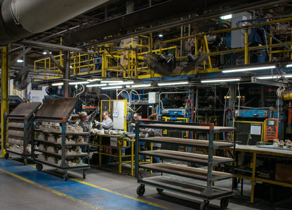 Workers at Wabash Castings, LLC, a Wisconsin Aluminum Foundry company, work at a table in the core making area of the facility.