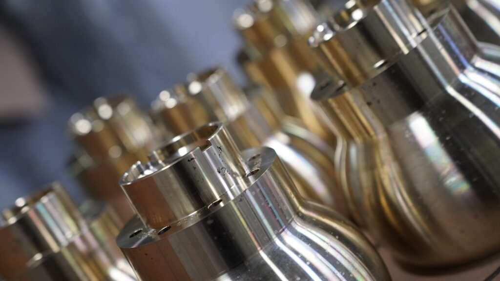Angled close-up of multiple bronze and brass components cast by Wisconsin Aluminum Foundry.