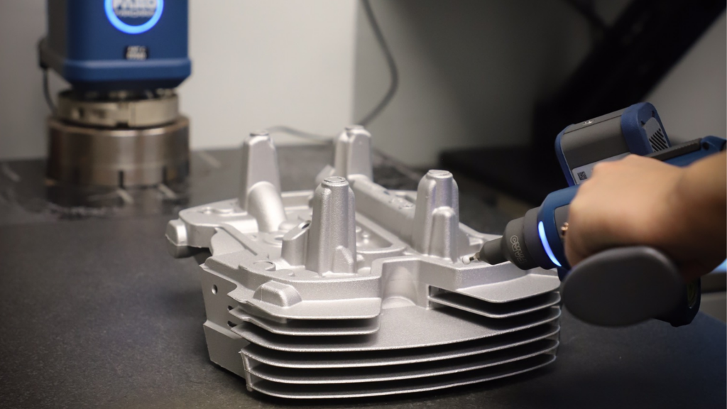 Worker inspects cast aluminum part at ATEK Metal Technologies, a Wisconsin Aluminum Foundry company in Iowa.