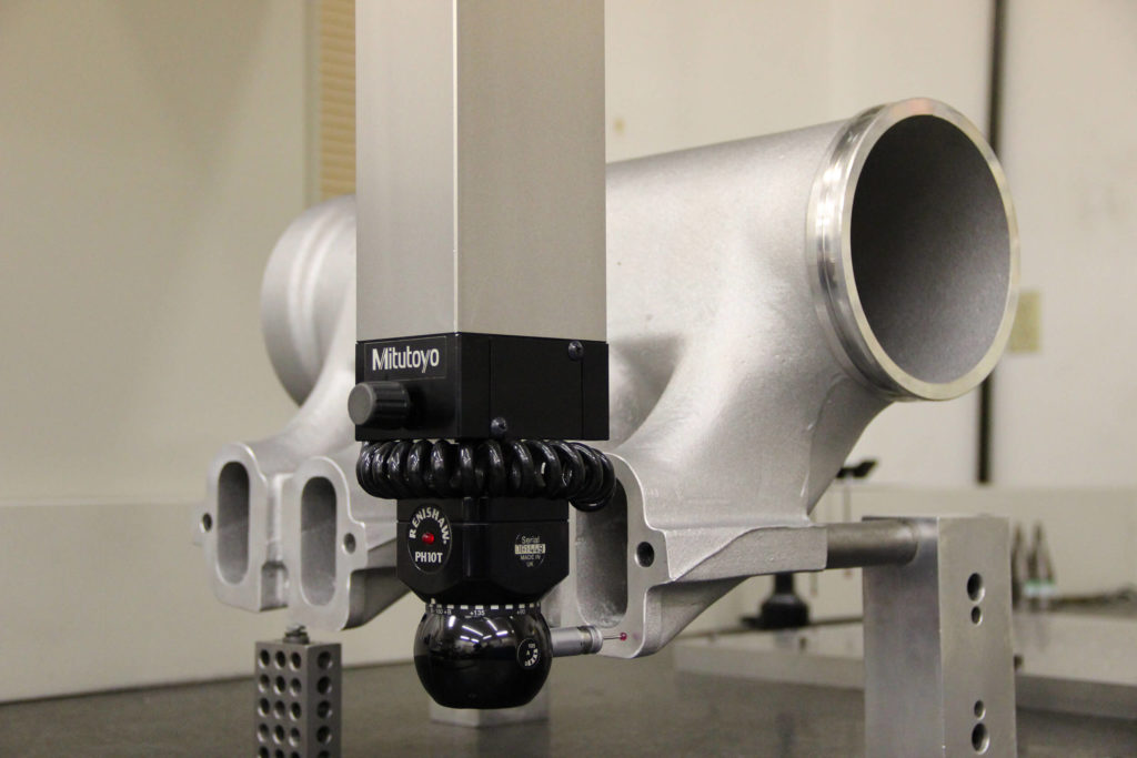 Close-up of Mitutoyo Automatic CMM quality inspection equipment.