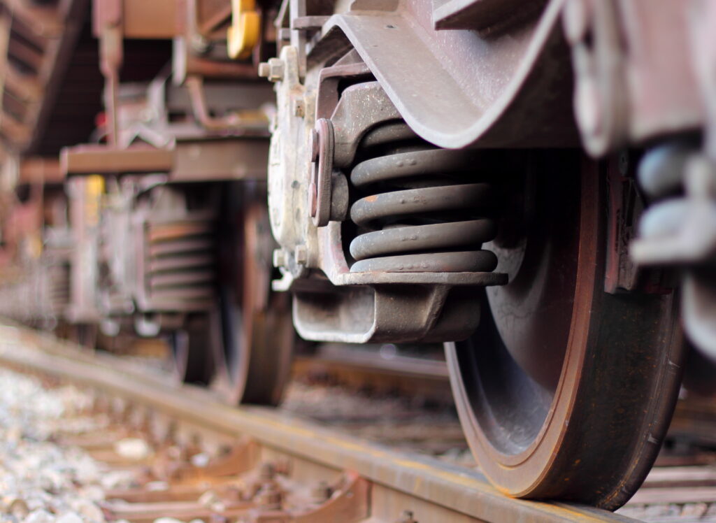 Close-up of train wheels on a railroad track.